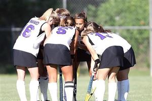 Girls field hockey huddle